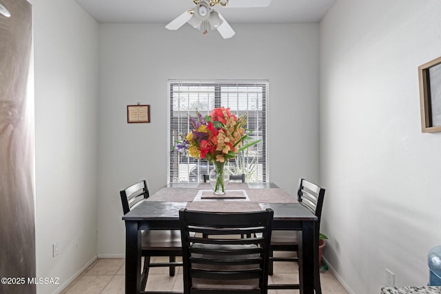 dining space with ceiling fan, light tile patterned flooring, and baseboards