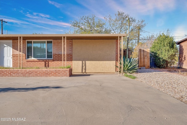 view of front of house featuring brick siding and stucco siding