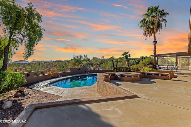 view of pool featuring a hot tub, a fenced in pool, and a patio