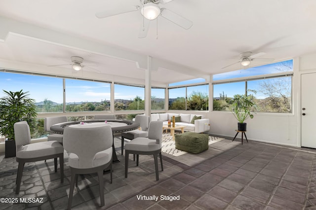 sunroom / solarium with a ceiling fan