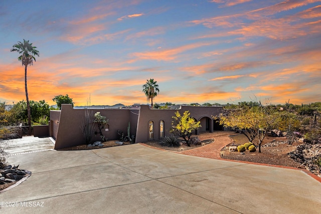 patio terrace at dusk with concrete driveway