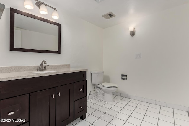 bathroom featuring toilet, vanity, visible vents, and tile patterned floors