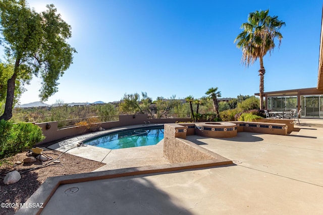 view of pool with a fenced backyard, a mountain view, a fenced in pool, a patio area, and a hot tub