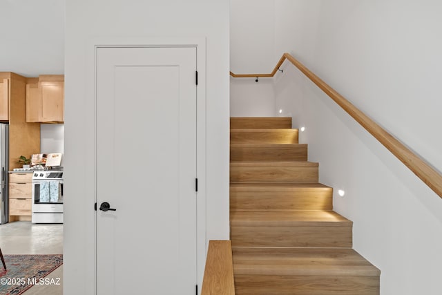 stairway with concrete flooring