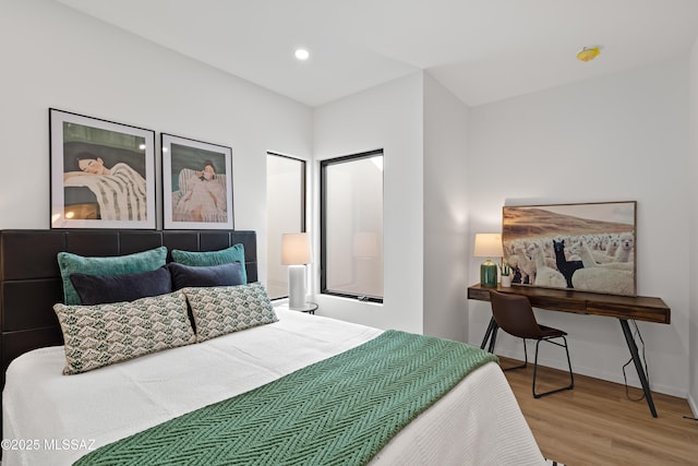 bedroom featuring recessed lighting, wood finished floors, and baseboards