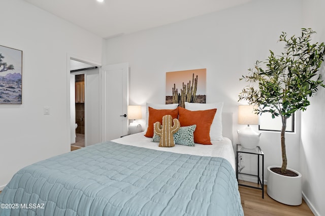 bedroom featuring wood finished floors