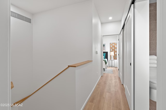 hallway featuring recessed lighting, visible vents, light wood-style flooring, and baseboards