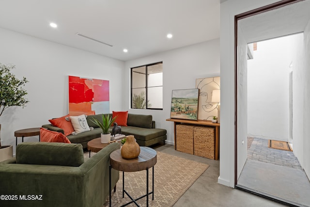 living room with concrete floors, visible vents, and recessed lighting