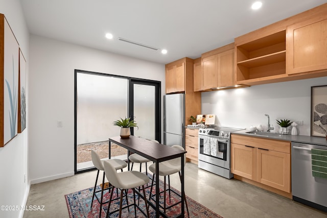 kitchen featuring light brown cabinets, appliances with stainless steel finishes, concrete floors, a sink, and recessed lighting