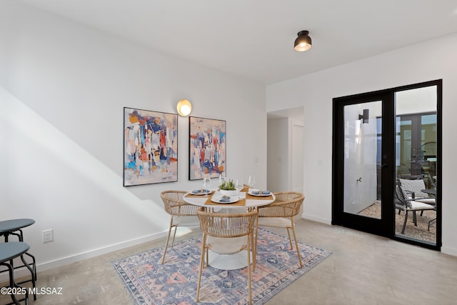 dining area featuring french doors and baseboards