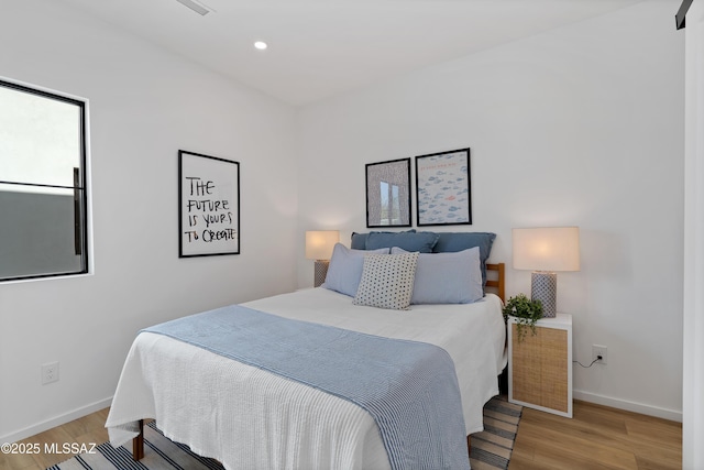 bedroom featuring recessed lighting, baseboards, and light wood finished floors