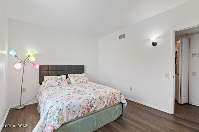 bedroom featuring dark wood-style floors, baseboards, and visible vents