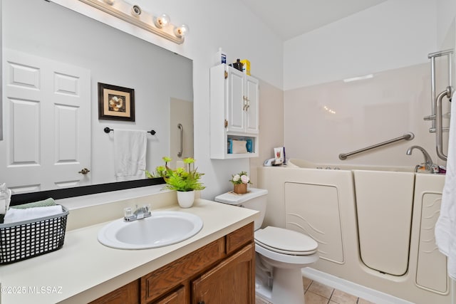 bathroom with toilet, tile patterned flooring, vanity, and a bath