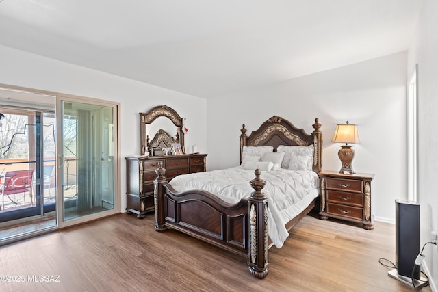 bedroom featuring access to outside and wood finished floors