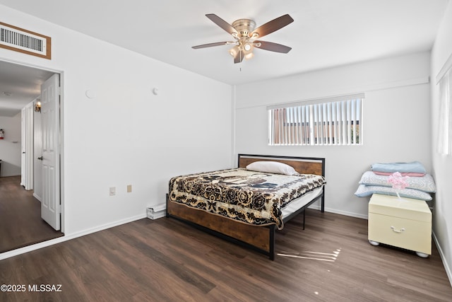 bedroom featuring baseboards, visible vents, dark wood finished floors, and a ceiling fan