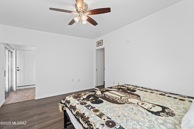 bedroom featuring a ceiling fan, dark wood finished floors, visible vents, and baseboards