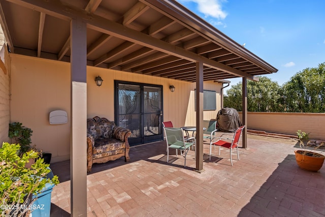 view of patio featuring outdoor dining space, french doors, and fence