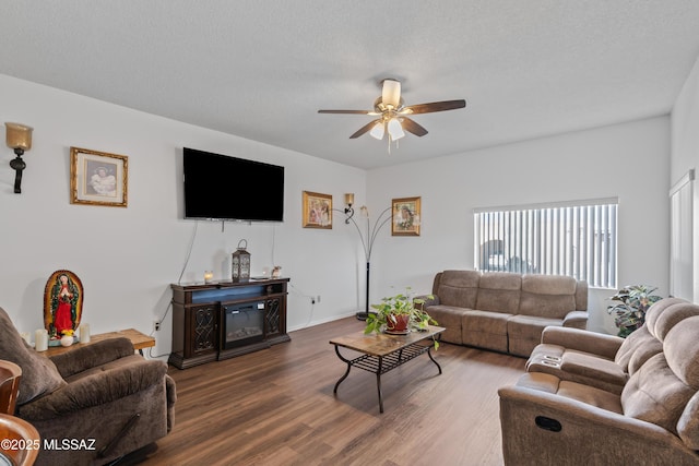 living room featuring dark wood finished floors, a textured ceiling, and ceiling fan