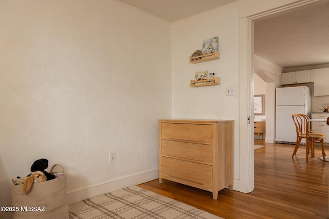 interior space with baseboards and wood finished floors