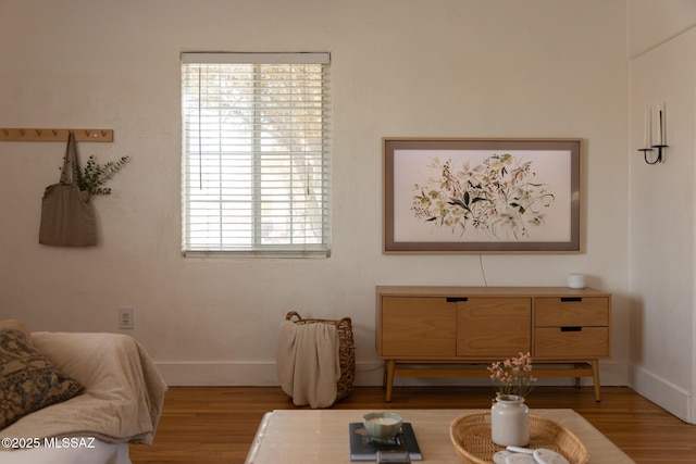 interior space featuring baseboards and wood finished floors