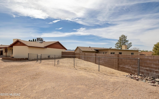 view of yard featuring central air condition unit and a fenced backyard