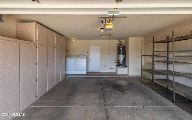 garage with a garage door opener, water heater, and separate washer and dryer