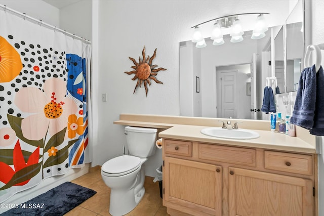 bathroom with a shower with shower curtain, vanity, toilet, and tile patterned floors