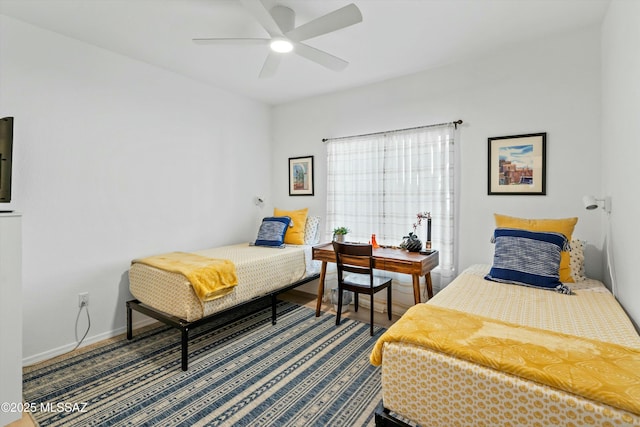 bedroom featuring ceiling fan and baseboards