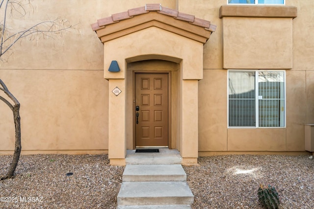 entrance to property with stucco siding