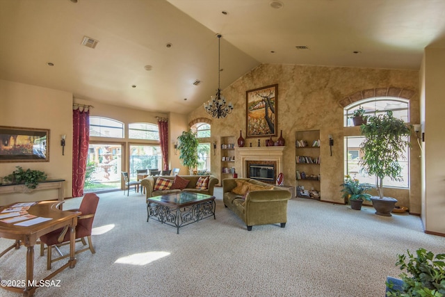 carpeted living area featuring high vaulted ceiling, a glass covered fireplace, and visible vents