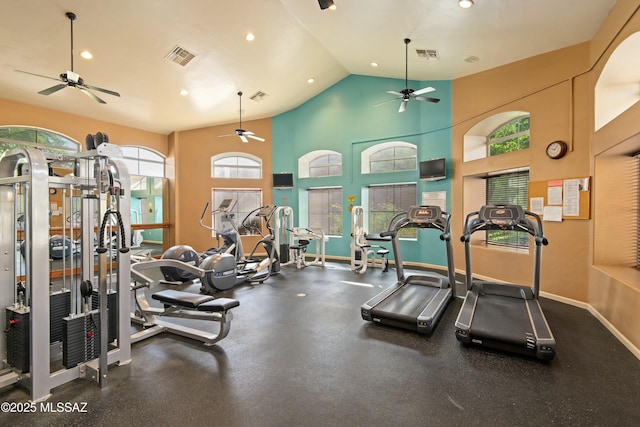 workout area with high vaulted ceiling, baseboards, and visible vents