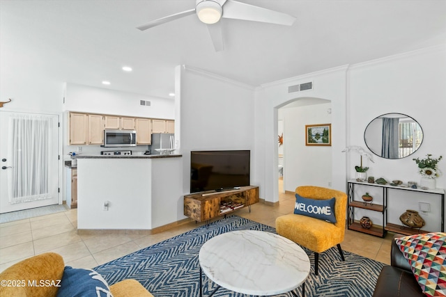 living room with light tile patterned floors, visible vents, arched walkways, and crown molding