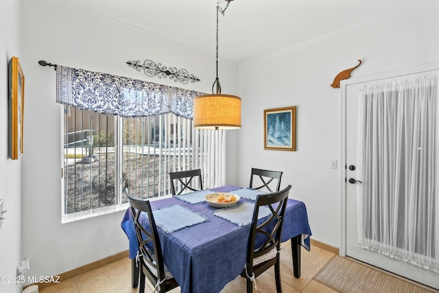 dining space featuring baseboards and light tile patterned flooring