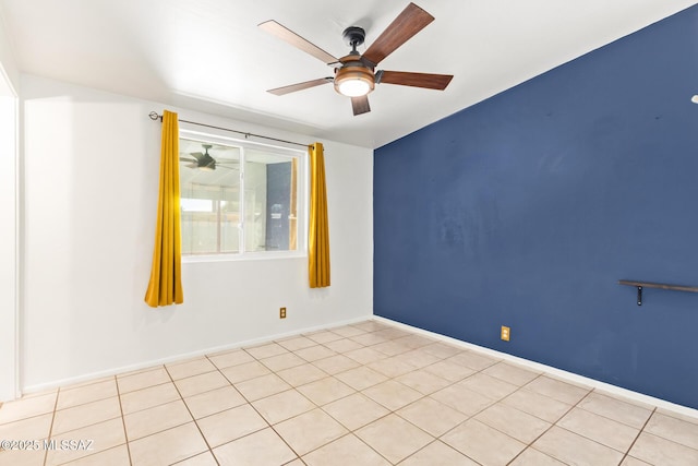 unfurnished room with ceiling fan and baseboards