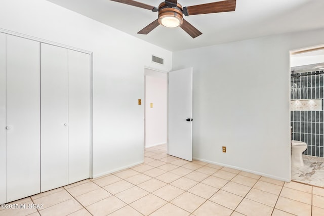 unfurnished bedroom with light tile patterned floors, a closet, and visible vents