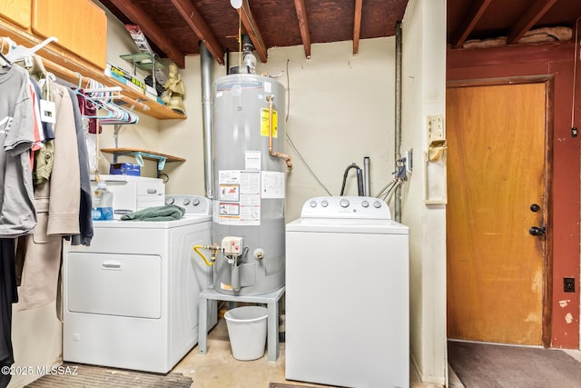 washroom featuring washing machine and dryer, laundry area, and water heater