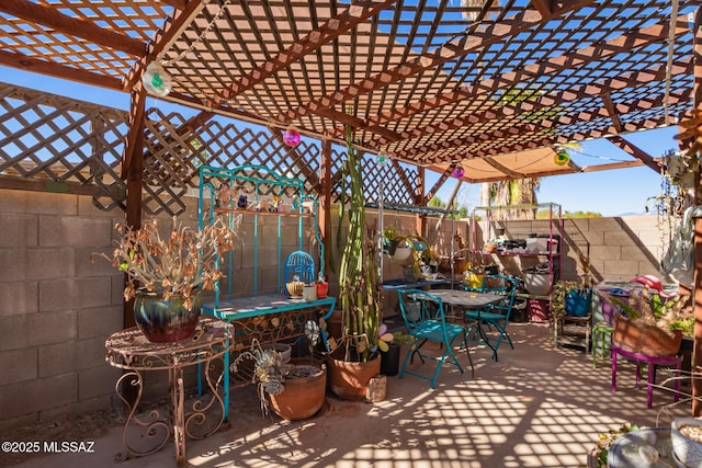 view of patio / terrace featuring fence and a pergola