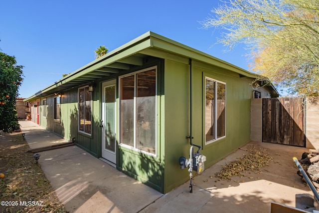 view of side of home with fence