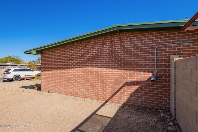 view of property exterior with brick siding