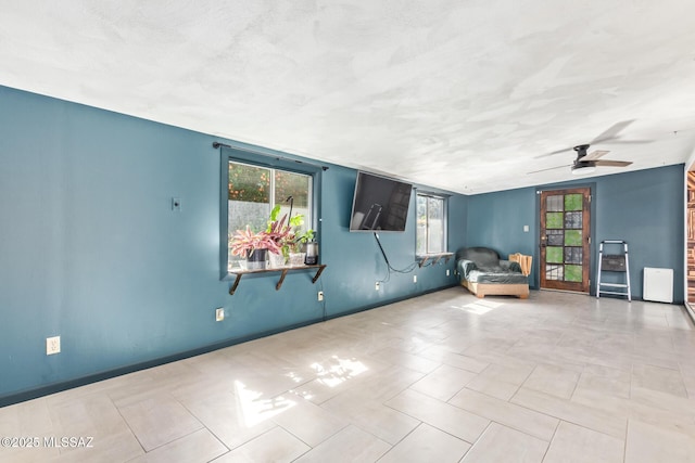 interior space featuring ceiling fan and a textured ceiling