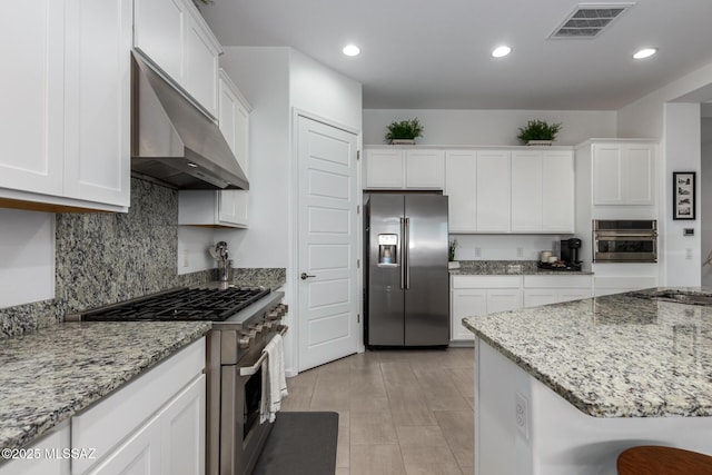 kitchen with stainless steel appliances, range hood, visible vents, and white cabinetry