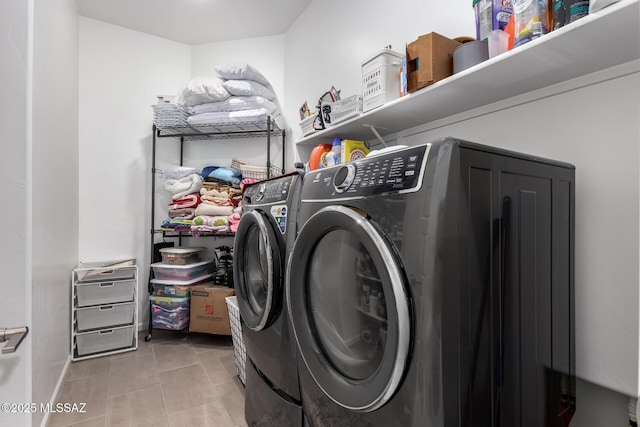 laundry room featuring light tile patterned floors, laundry area, and washer and dryer