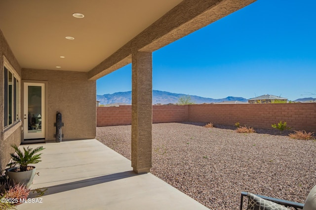 view of patio featuring a fenced backyard and a mountain view