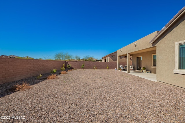 view of yard featuring a fenced backyard and a patio