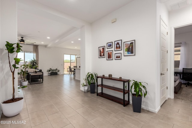 hallway with recessed lighting, visible vents, baseboards, beamed ceiling, and light tile patterned flooring