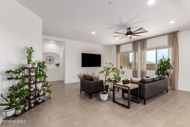 living room with ceiling fan, baseboards, and recessed lighting