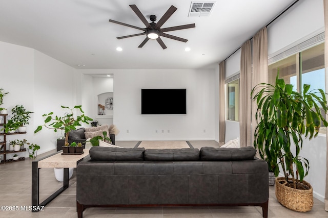 living area featuring baseboards, visible vents, a ceiling fan, and recessed lighting