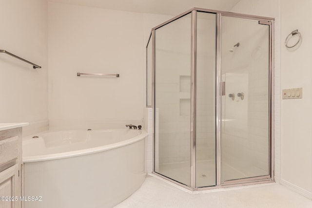 full bathroom featuring a garden tub and a shower stall