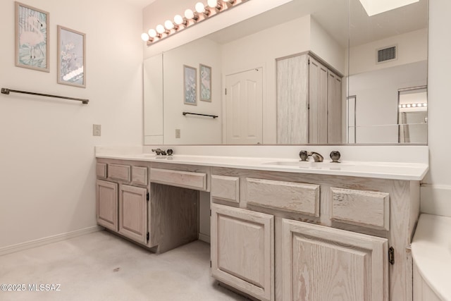 full bath with double vanity, a sink, visible vents, and baseboards