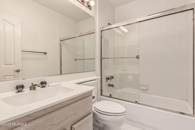 bathroom with toilet, bath / shower combo with glass door, and vanity